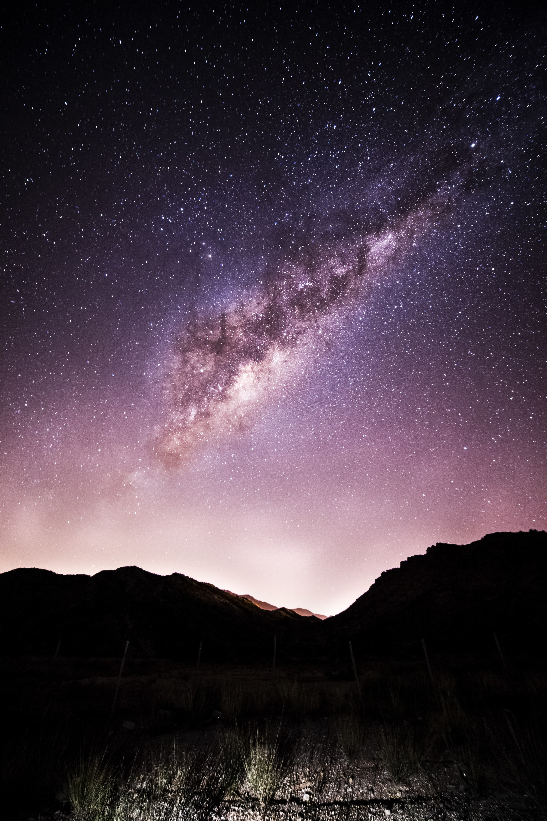 Amazing starry night sky over rocky terrain
